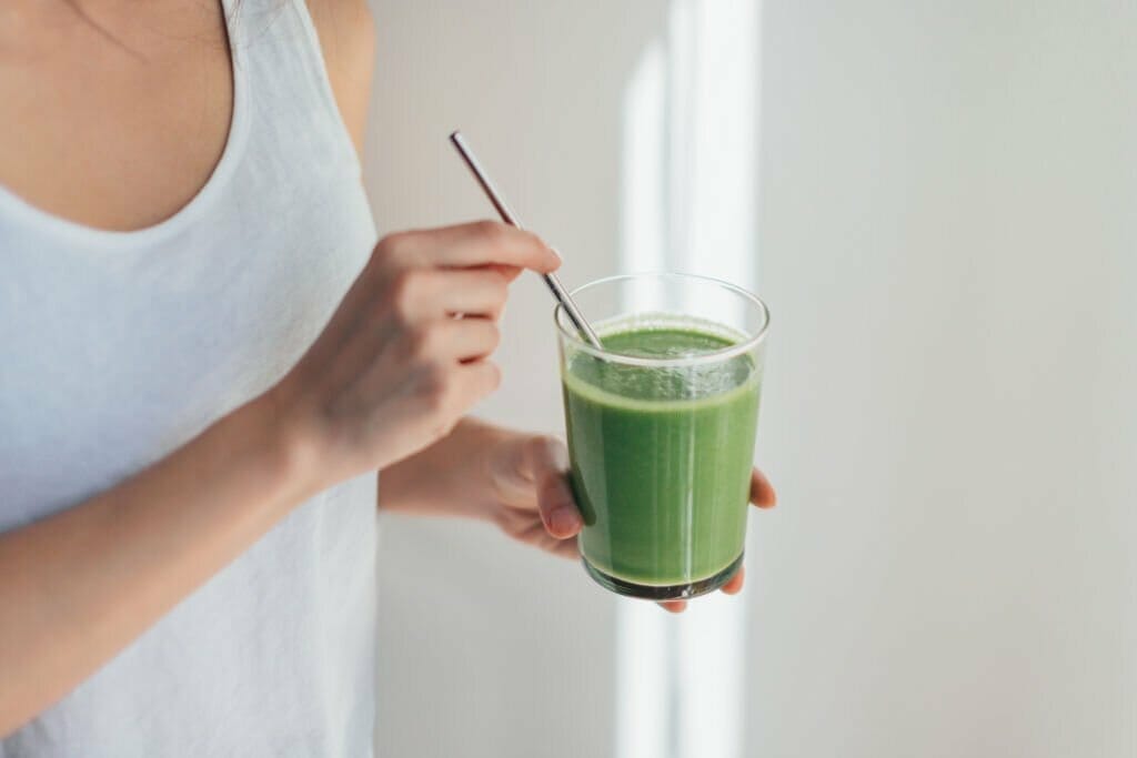 Young Woman Drinking Green Juice