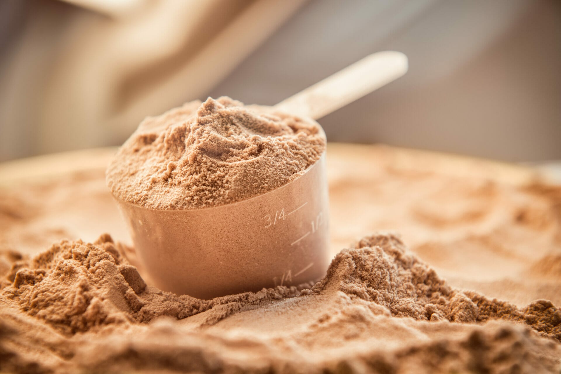 Chocolate whey protein powder with a filled scoop