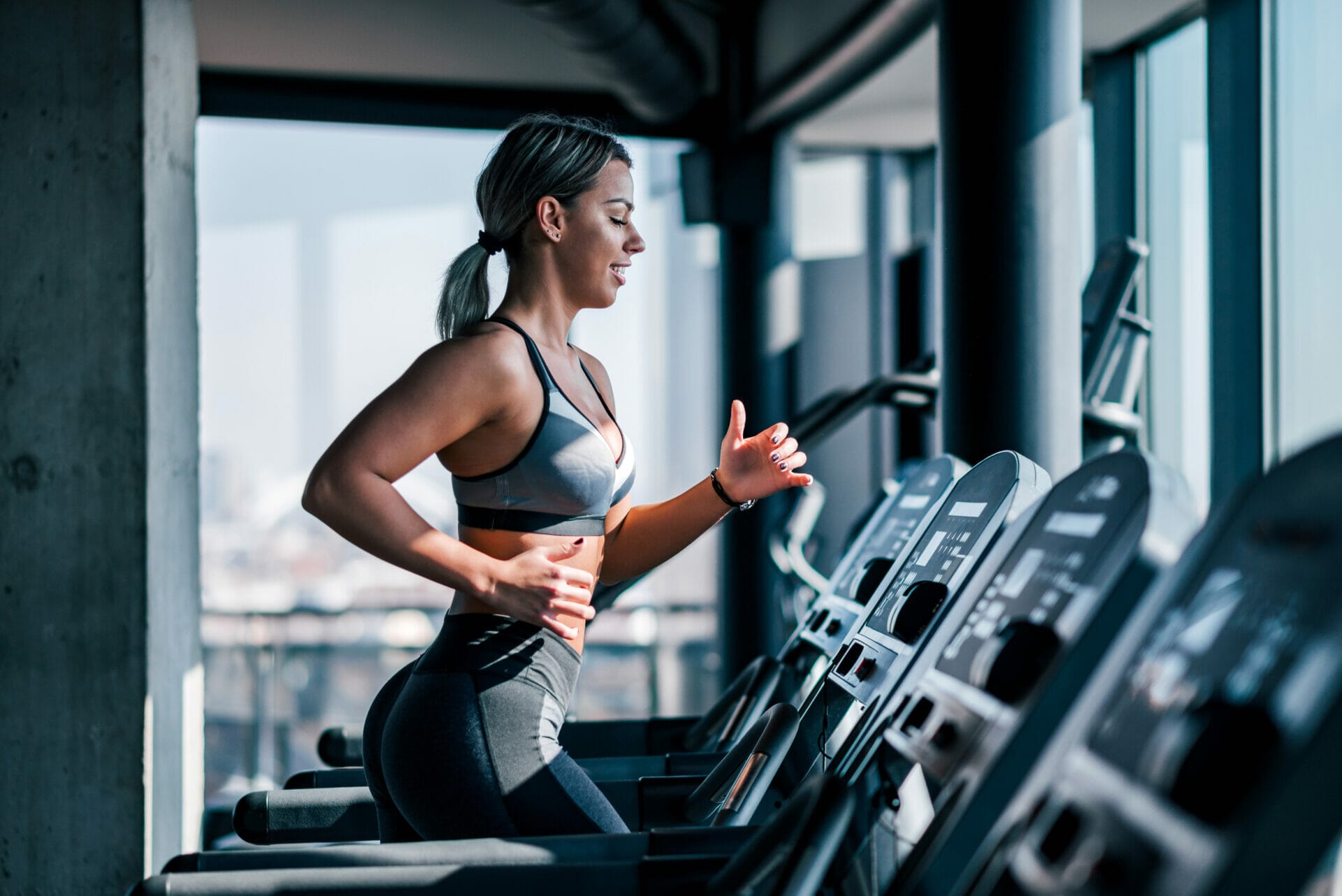 a girl running on treadmill in gym